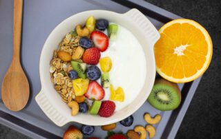 natural time granola in bowl with fruits
